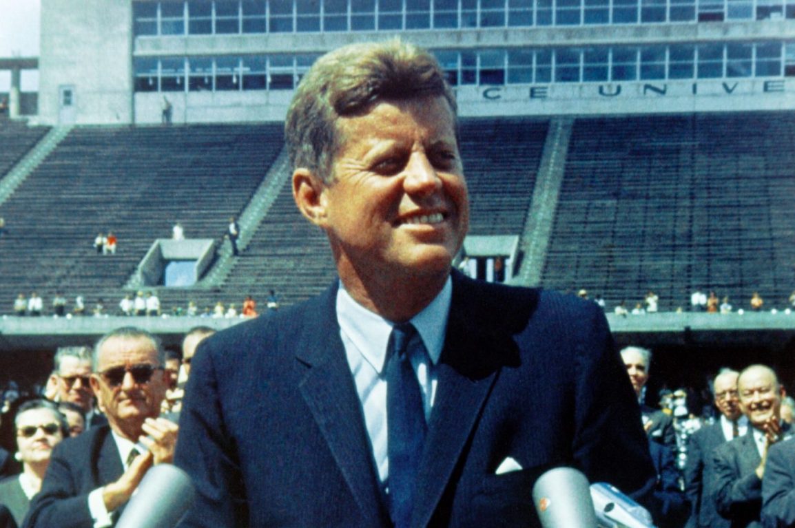 President JFK standing behind a podium