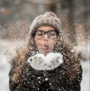 girl blowing snow