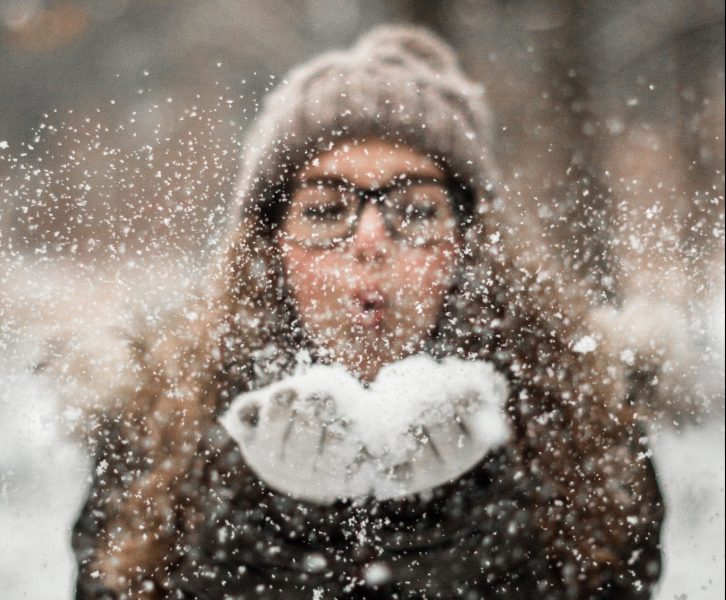 girl blowing snow